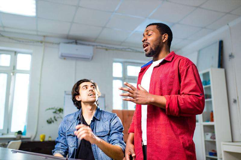 A group of friends enjoying a karaoke night together, showcasing how singing improves your social and professional lives