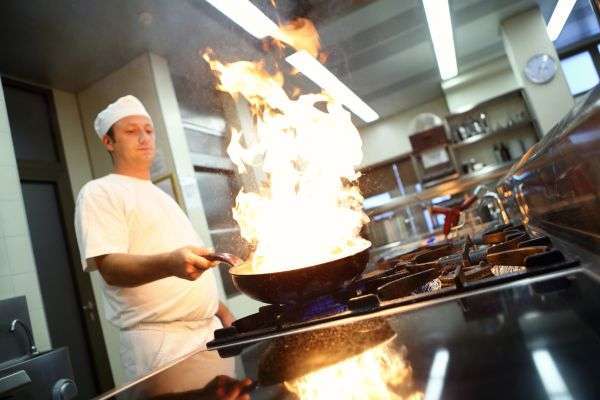 Knife skills demonstration in beginner cooking class
