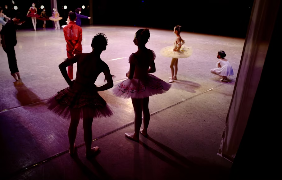 Children learning teamwork through arts education in dance class