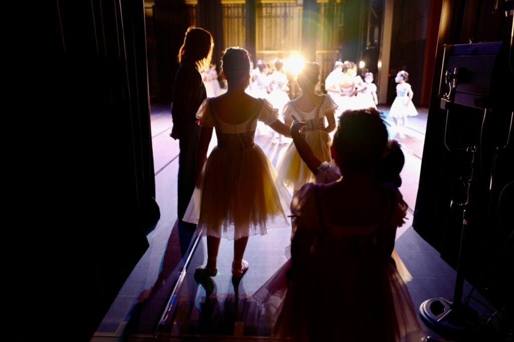 Students performing on stage to develop teamwork and communication skills through theater work